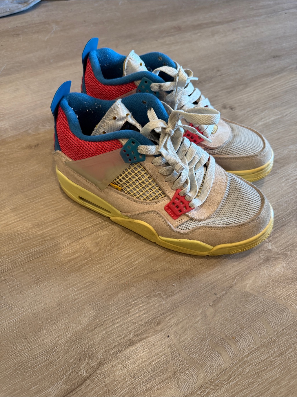 Nike Jordan 4 Union Beige Sneakers With Yellow, Blue & Red Accents